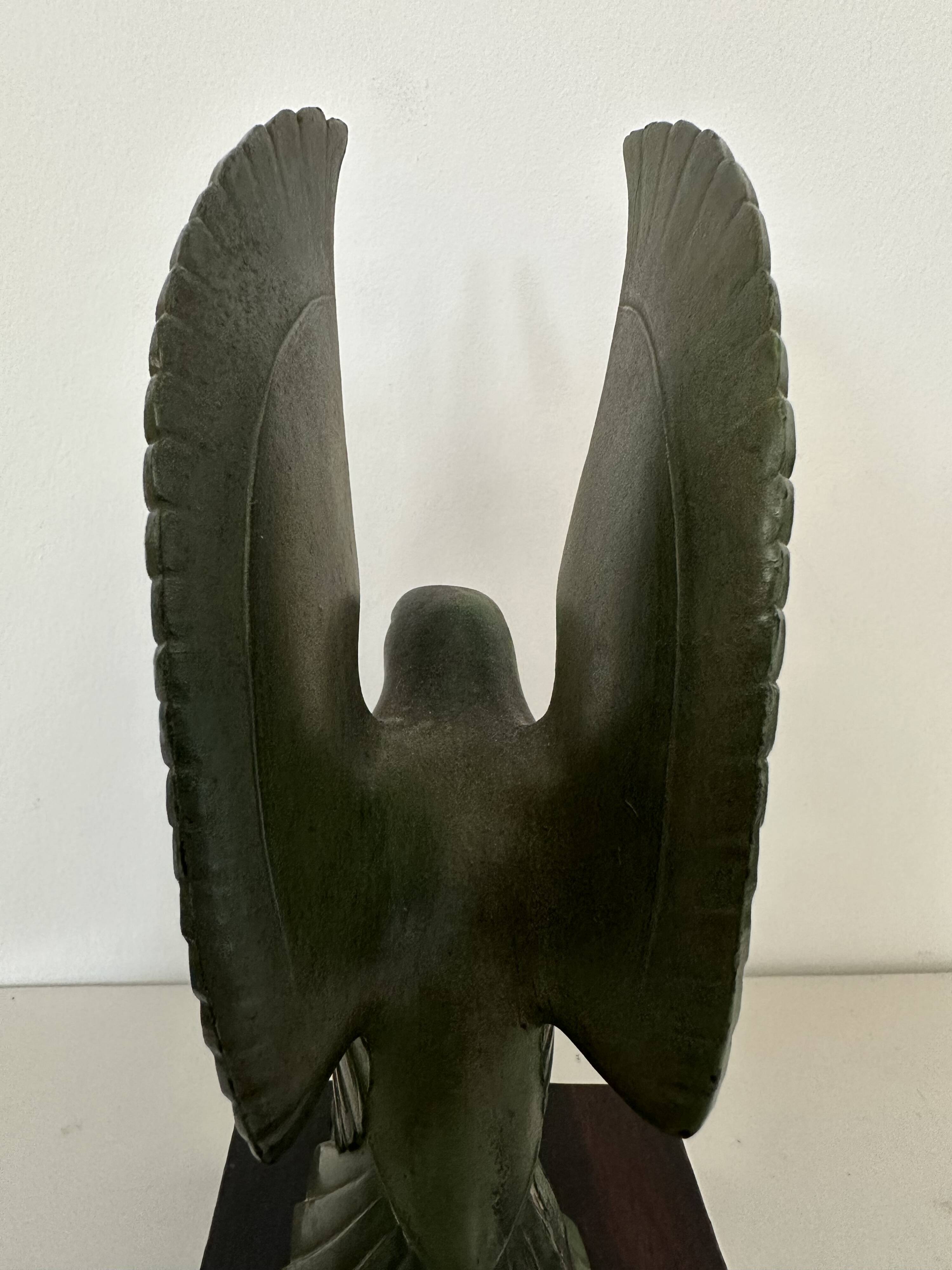 Pair of eagle bookends in green patina regula with rosewood base