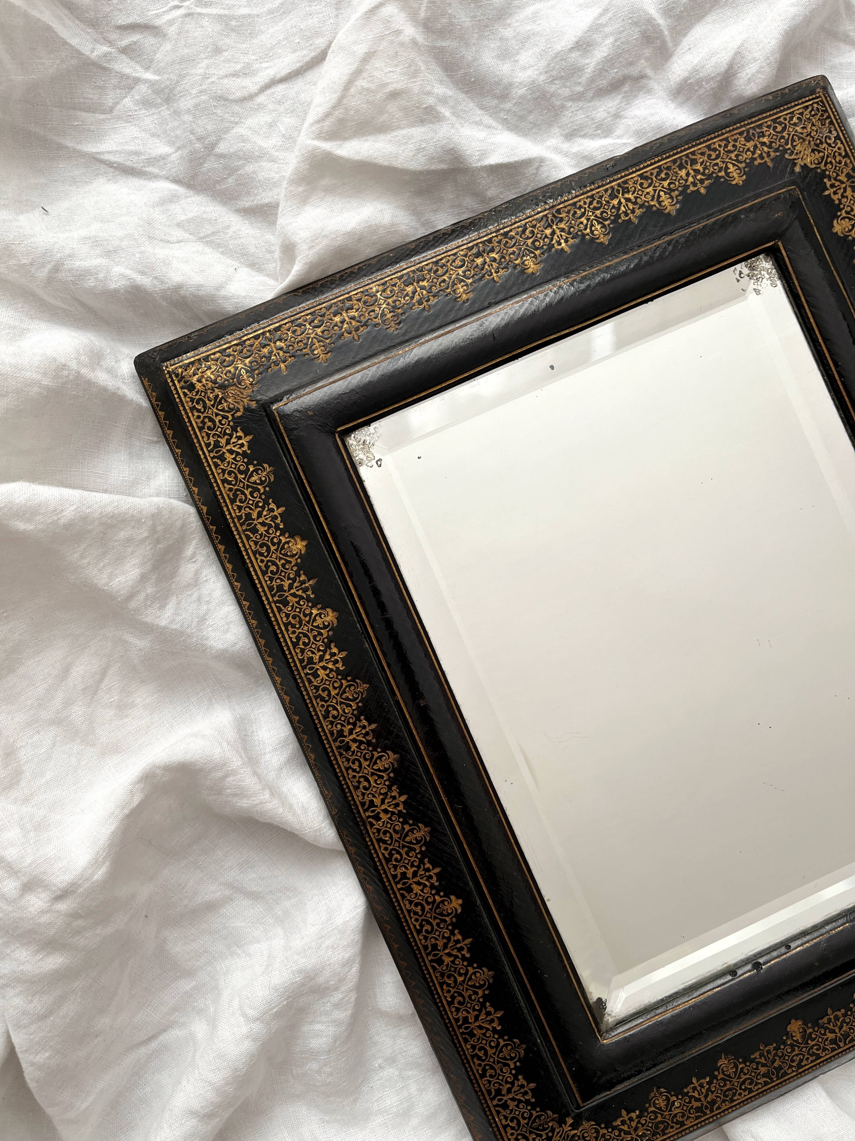 Old beveled mirror with black and gold leather binding Napoleon III