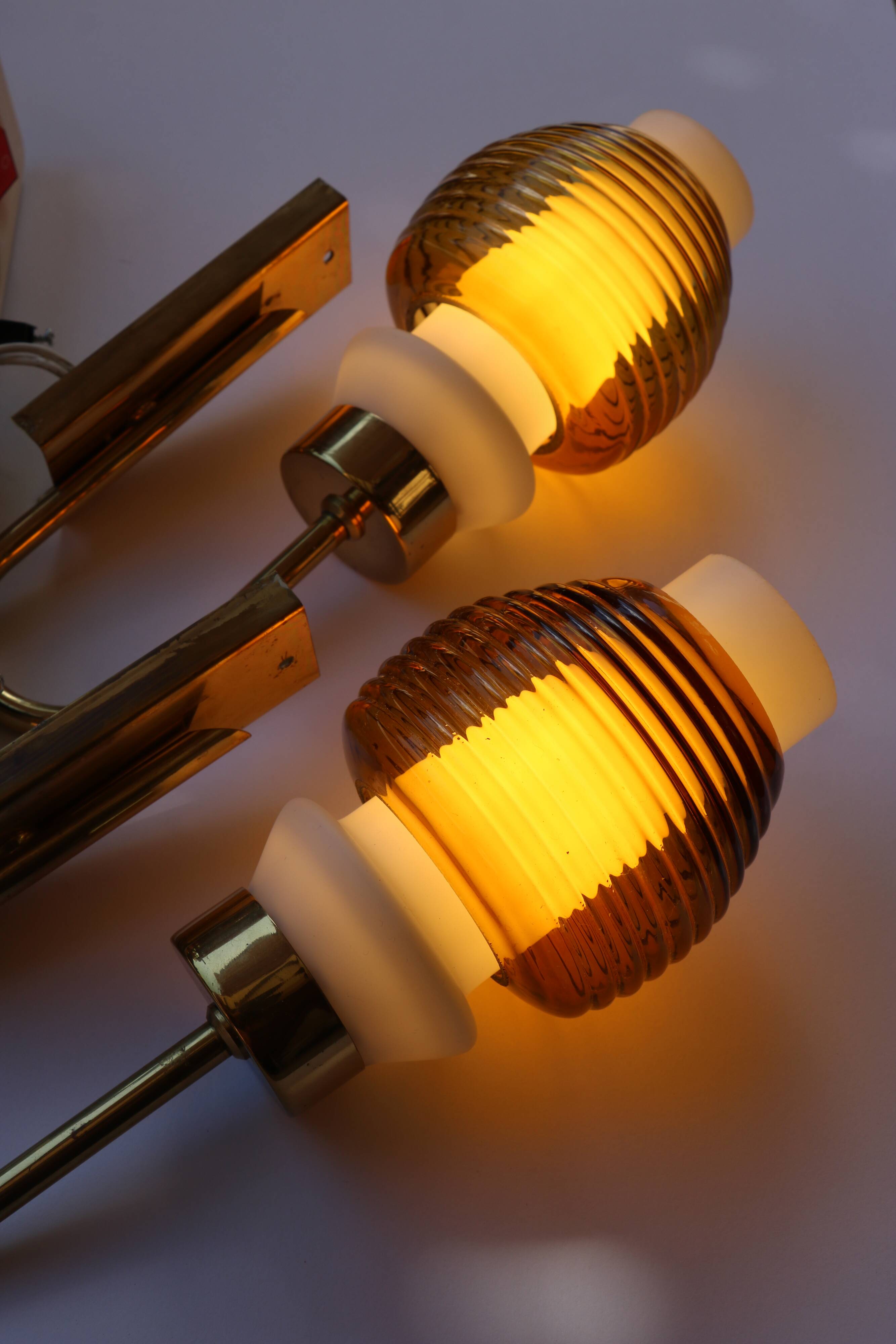 Pair of Scandinavian wall sconces, brass, opal glass and amber glass.