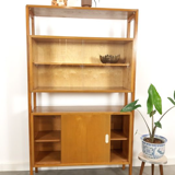 Vintage wooden showcase with sliding doors and white handles