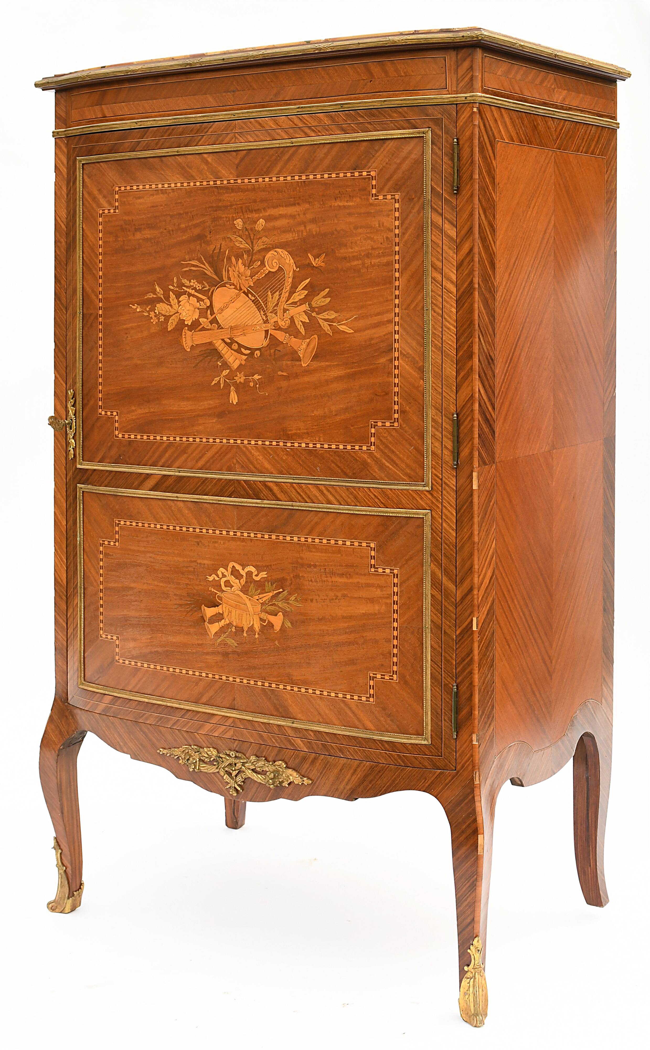 In-between furniture in marquetry decorated with a trophy decoration of musical instruments