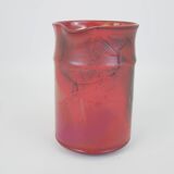 Red glazed ceramic jug with relief