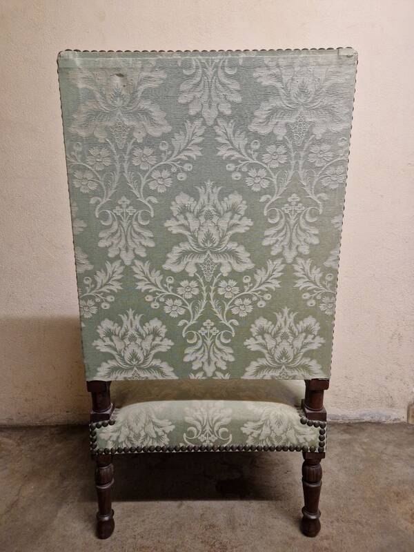 Antique Louis XIV style armchair in moulded wood and damask-style fabric.