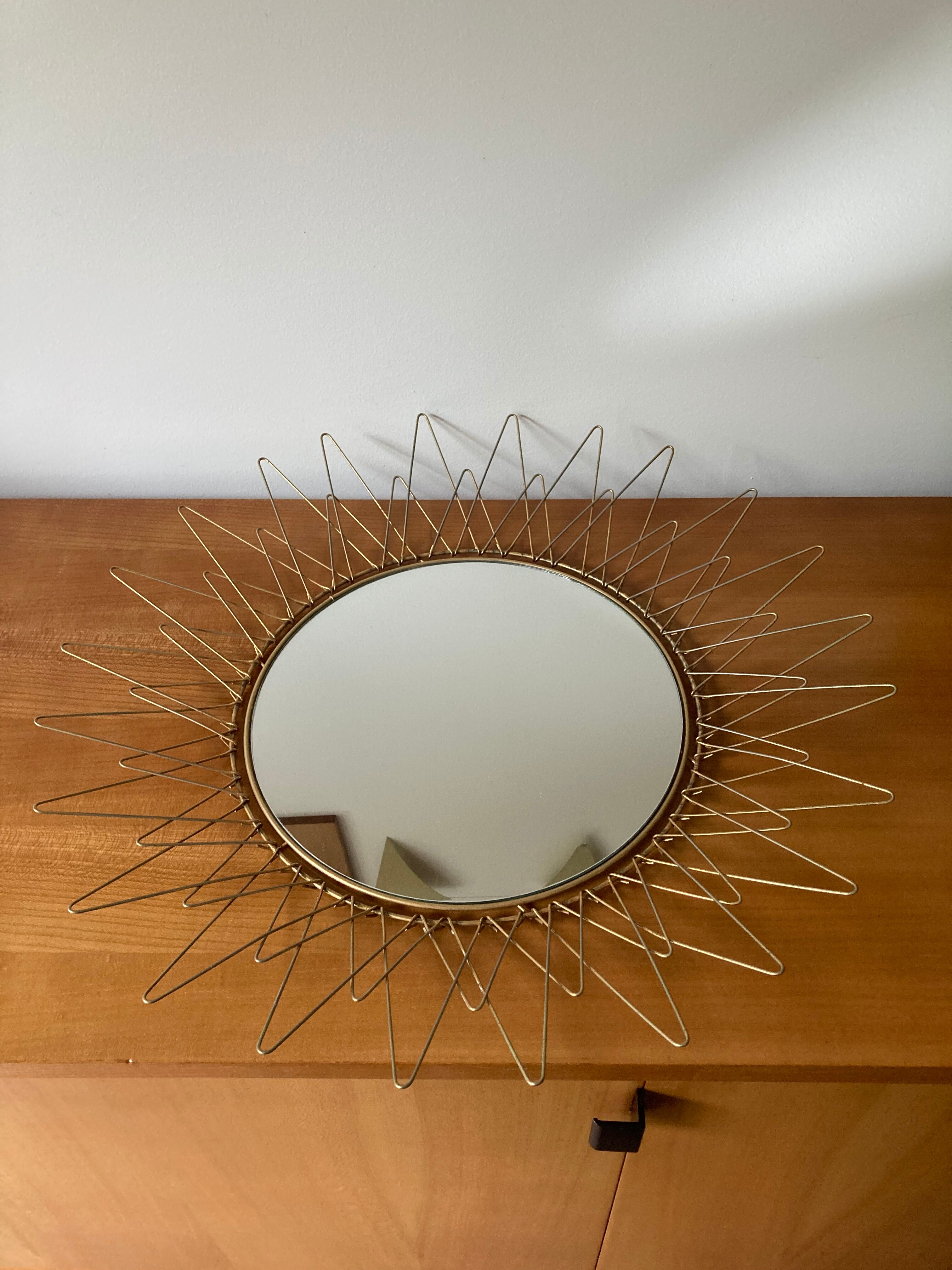 Sun mirror in gilded metal