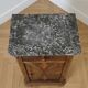 Antique bedside table in wood and grey marble, old brown.