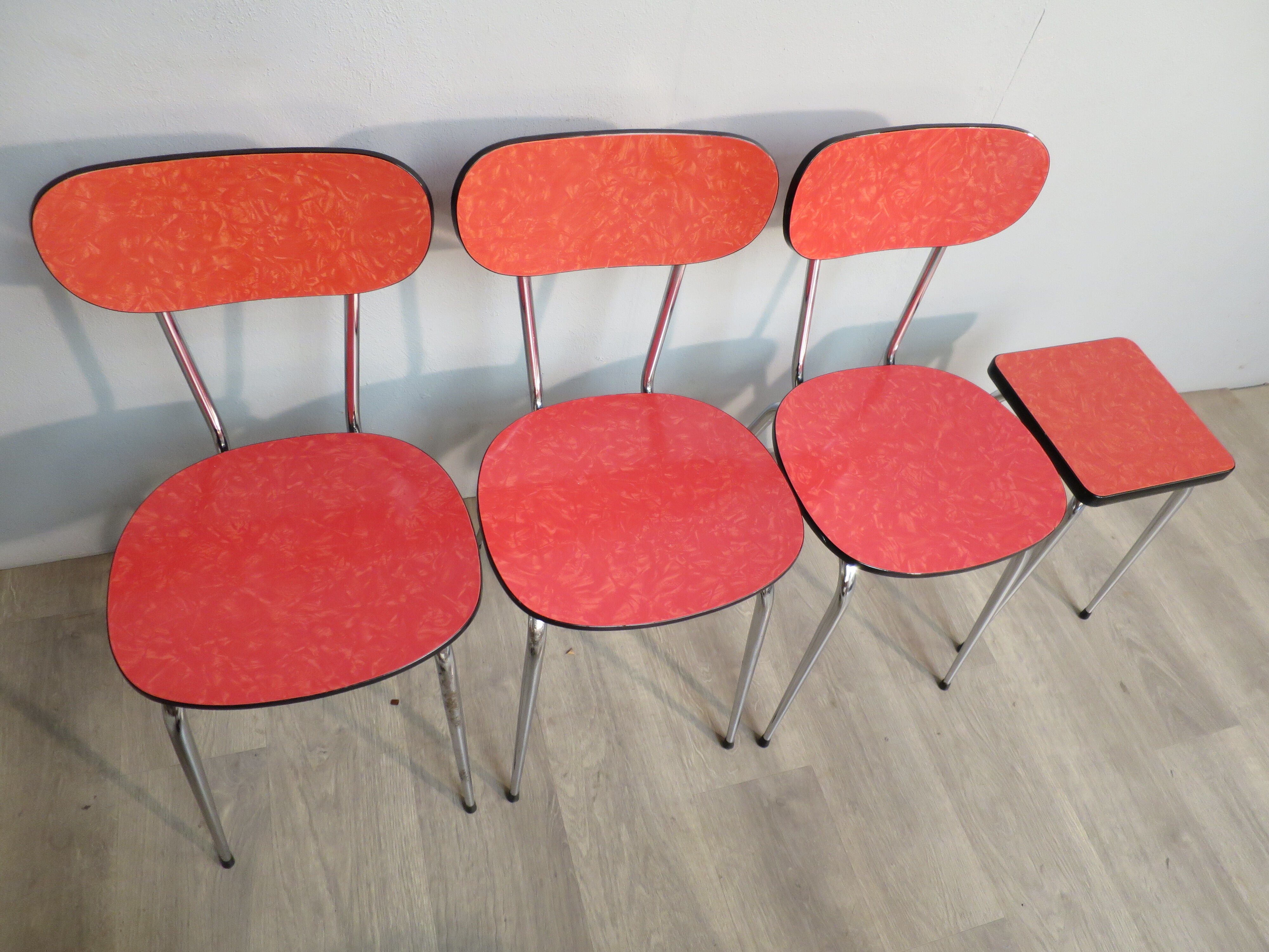 Table, 3 chairs and red formica stool