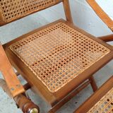 Pair of folding chairs in bamboo and caning, leather and brass