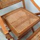Pair of folding chairs in bamboo and caning, leather and brass