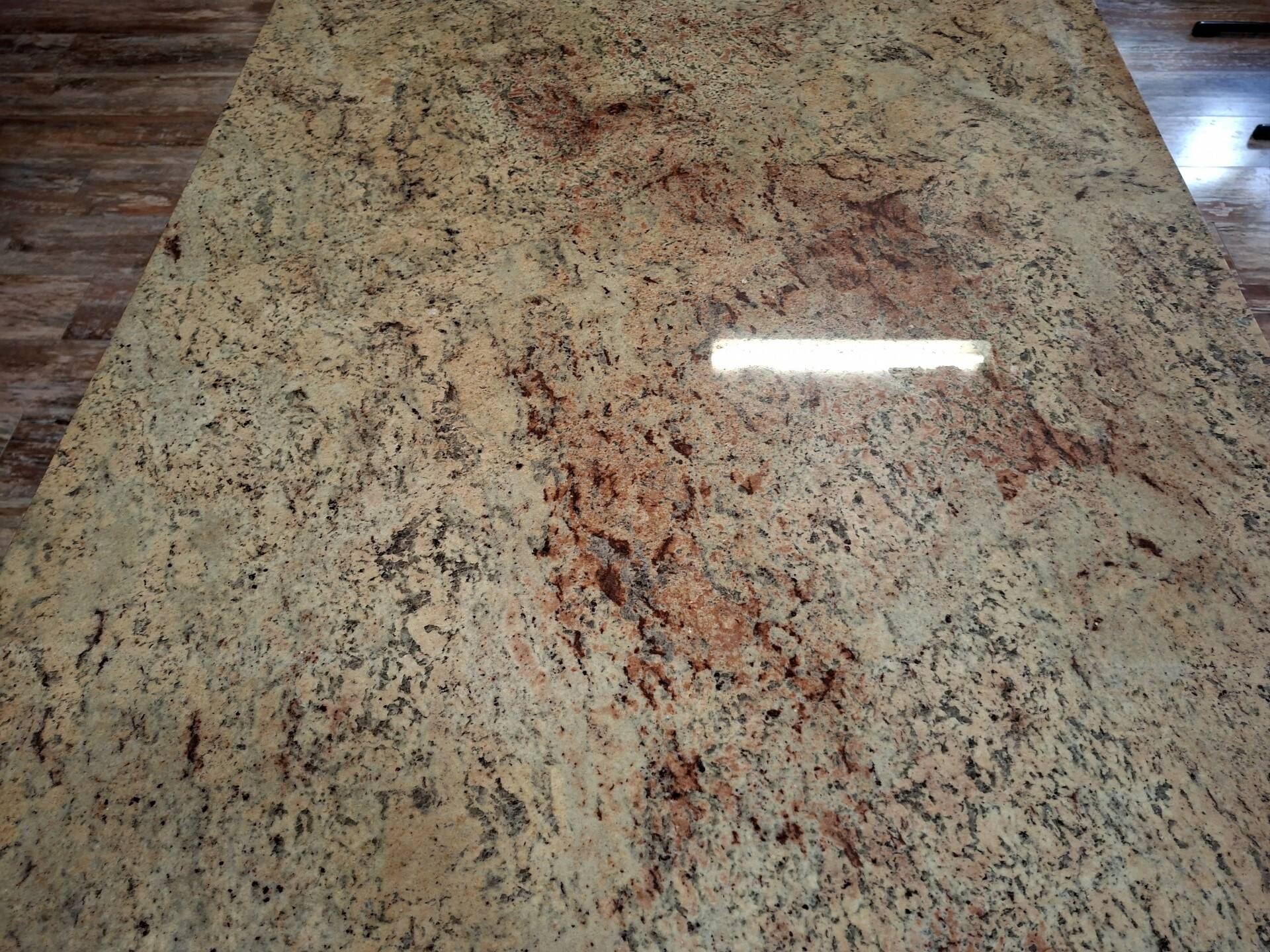Large polished granite dining table on an oak and iron base.