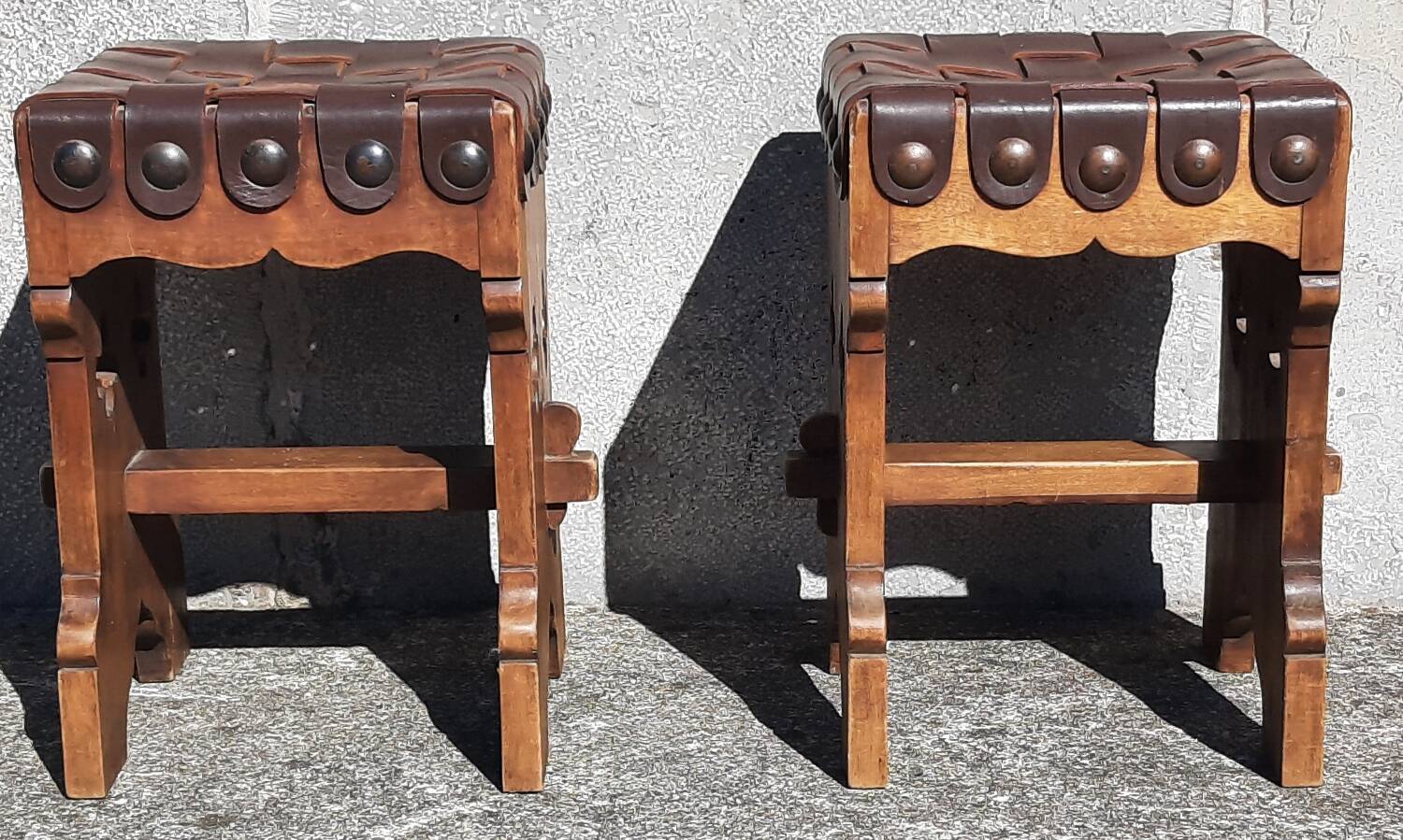 Pair of brutalist stools, leather seat.