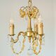 Small vintage brass chandelier with amber crystal pendants.