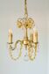 Small vintage brass chandelier with amber crystal pendants.