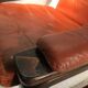 Duo of ochre leather and wood frame armchairs