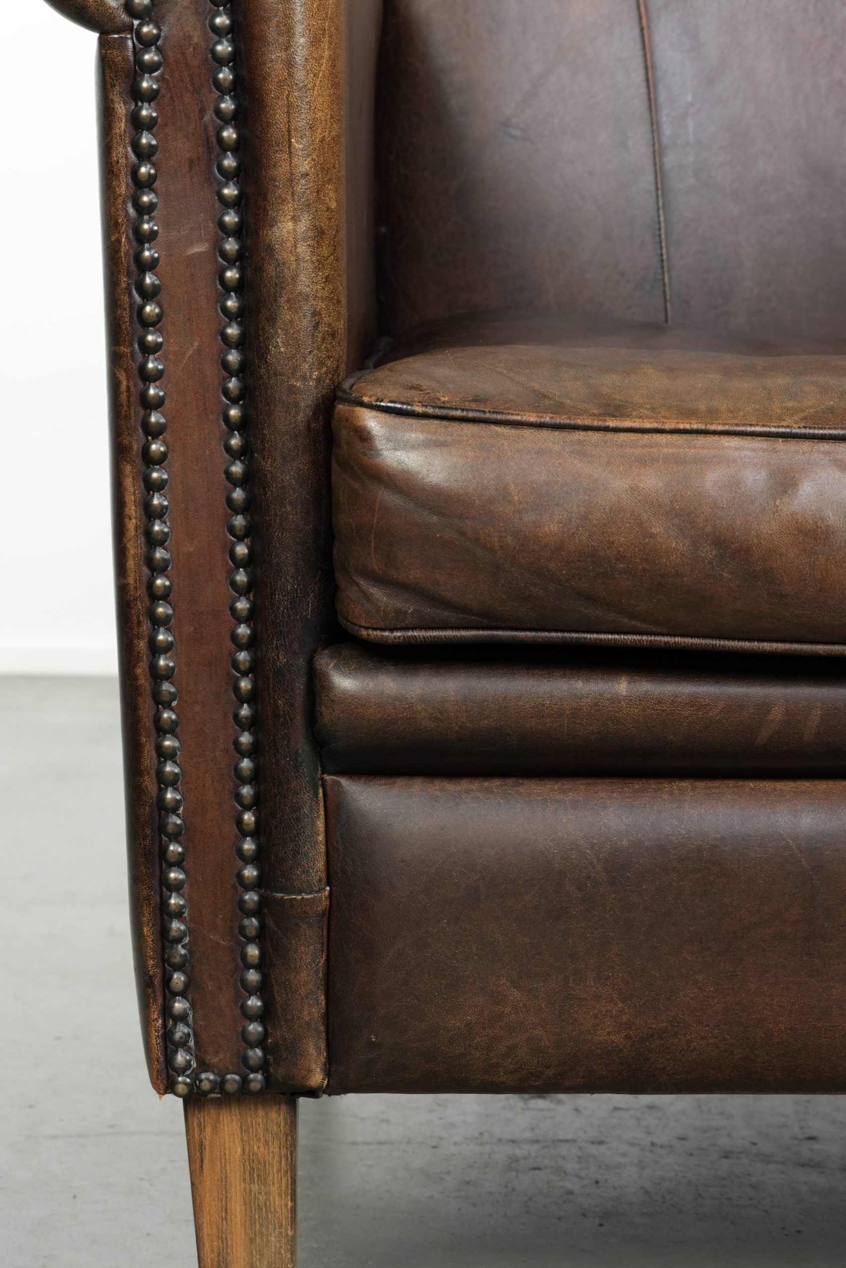 Characterful set of two sheepskin design armchairs with beautiful patina