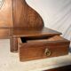 Antique carved wooden dressing table with marble and tilting oval mirror.