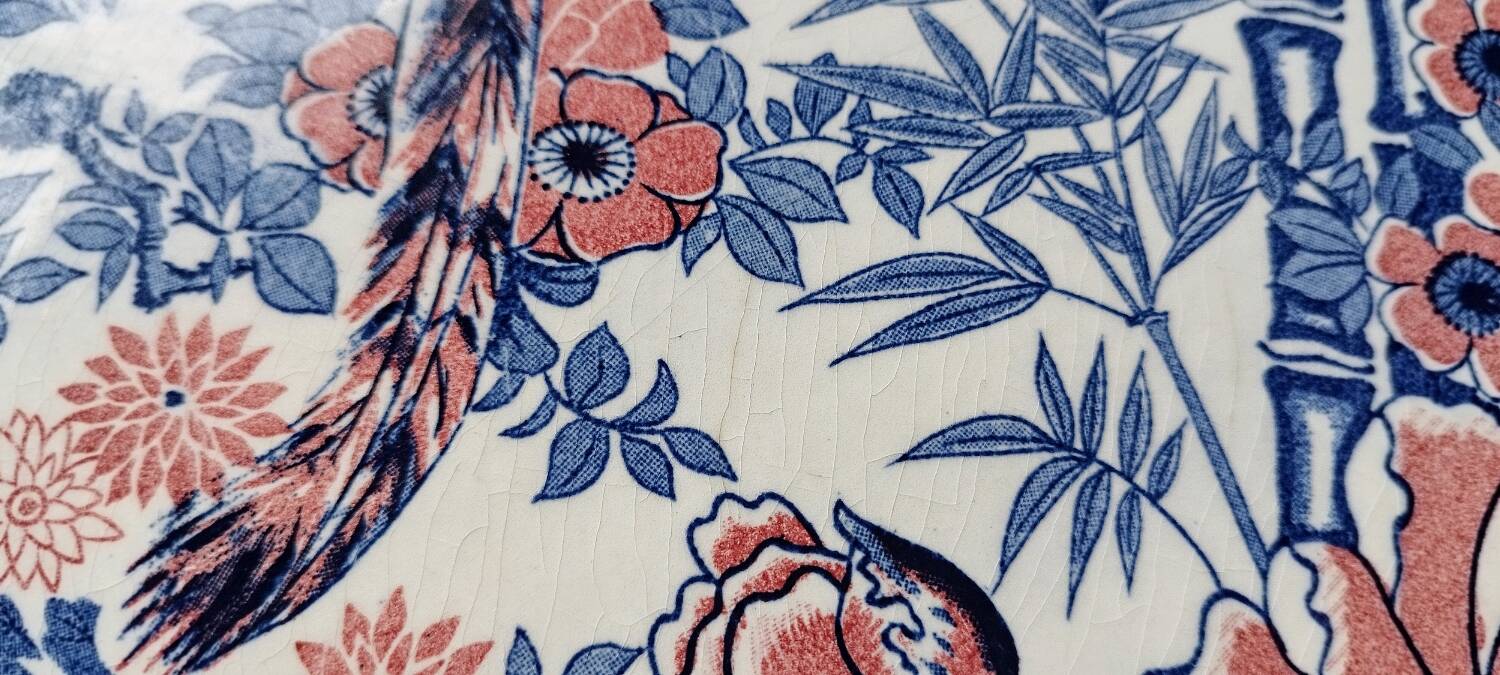 Oval Japanese plate with peacock decoration.