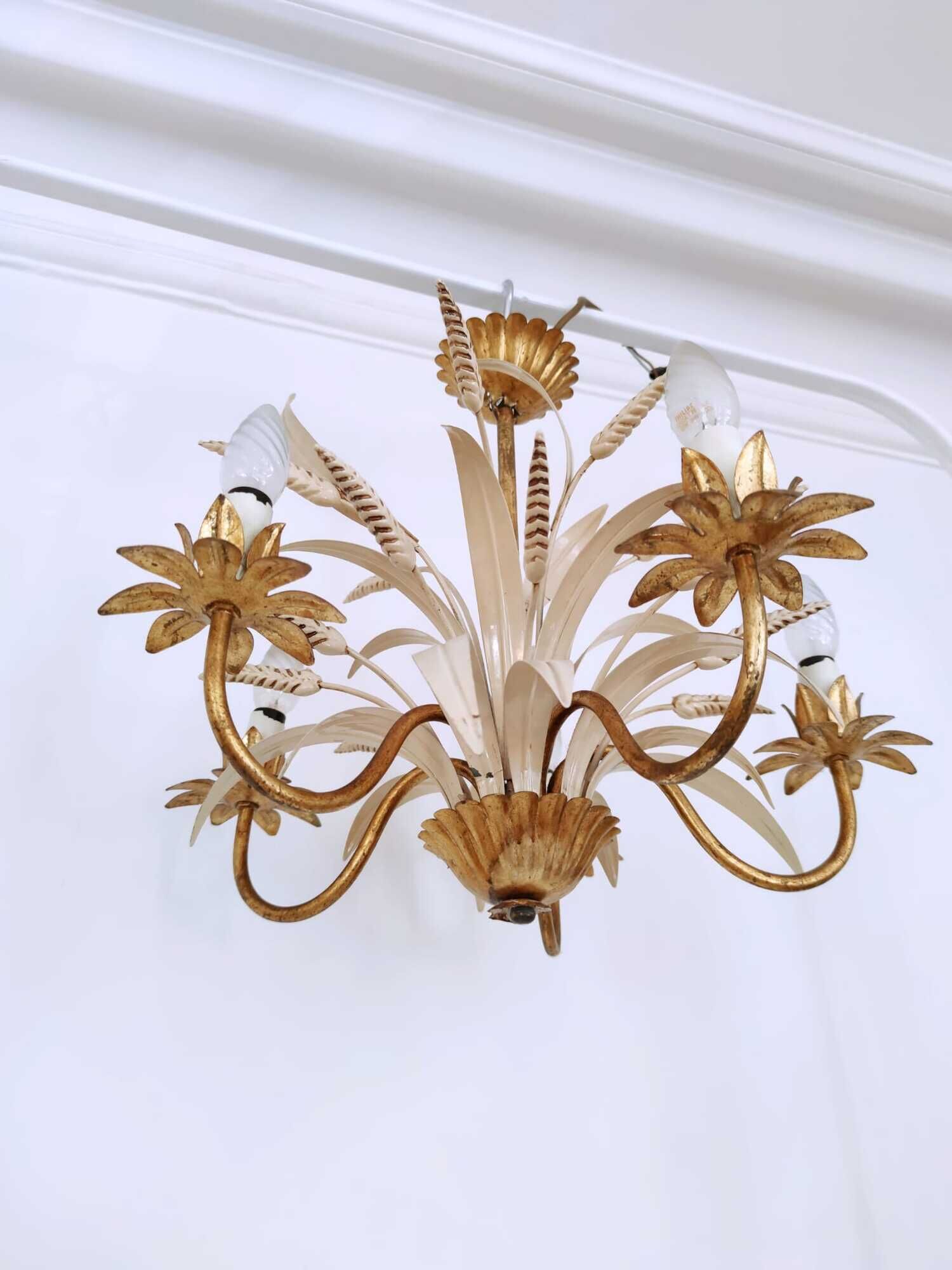 Vintage wrought iron chandelier decorated with golden and beige reeds
