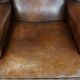 Vintage sheepskin wingback chair finished with black piping