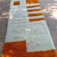 Handmade orange and white wool rug, traditionally crafted, size 140 x 260 cm