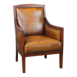 Sheepskin and wooden vintage Art Deco design armchair in a cognac color