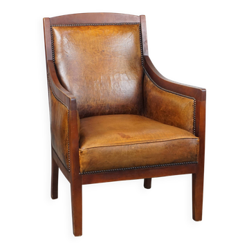 Fauteuil design Art Déco vintage en peau de mouton et bois de couleur cognac