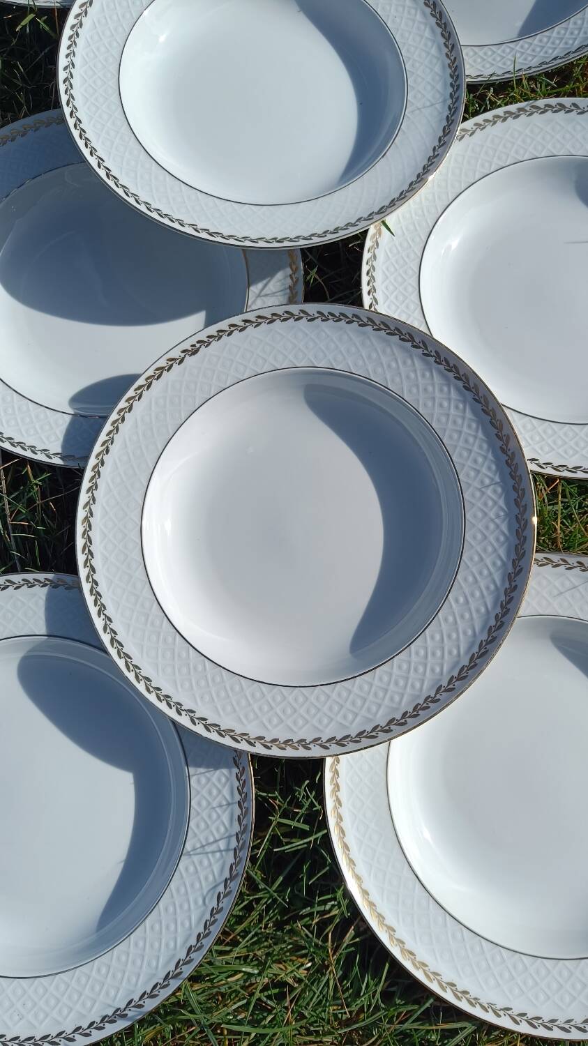 Twelve white porcelain plates