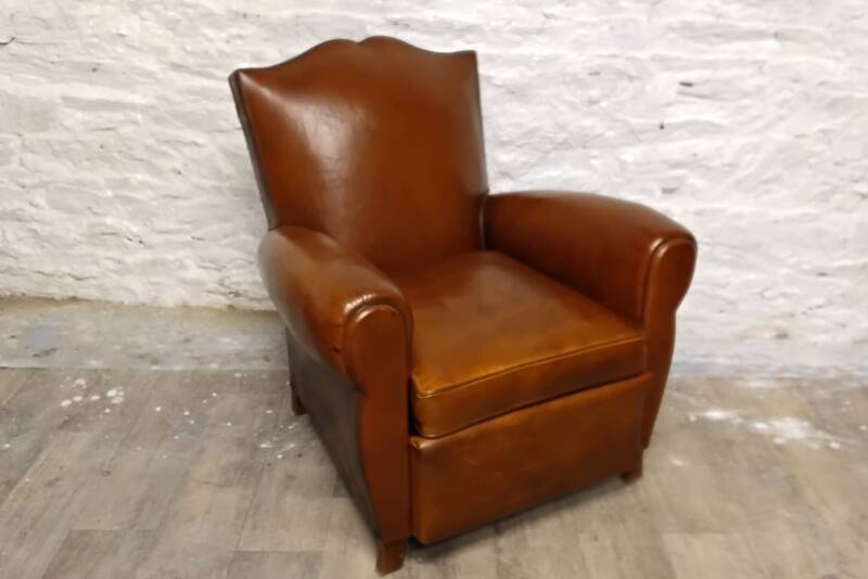 Antique club chair with mustache back