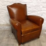 Antique club chair with mustache back