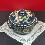 Small covered terracotta pot enamelled savoie or alsace flowers on a blue background