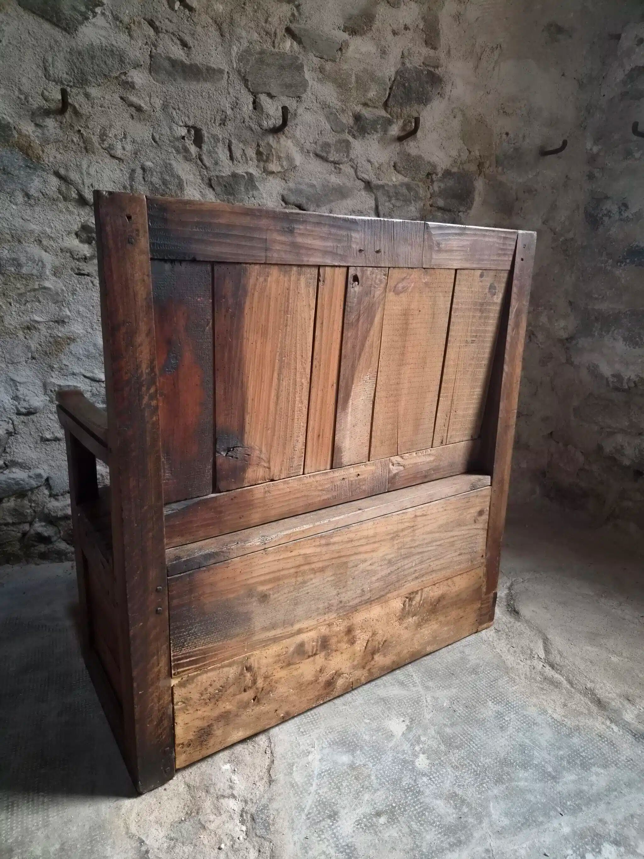 Rustic French antique storage bench from the 18th century in walnut and pine.