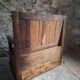 Rustic French antique storage bench from the 18th century in walnut and pine.
