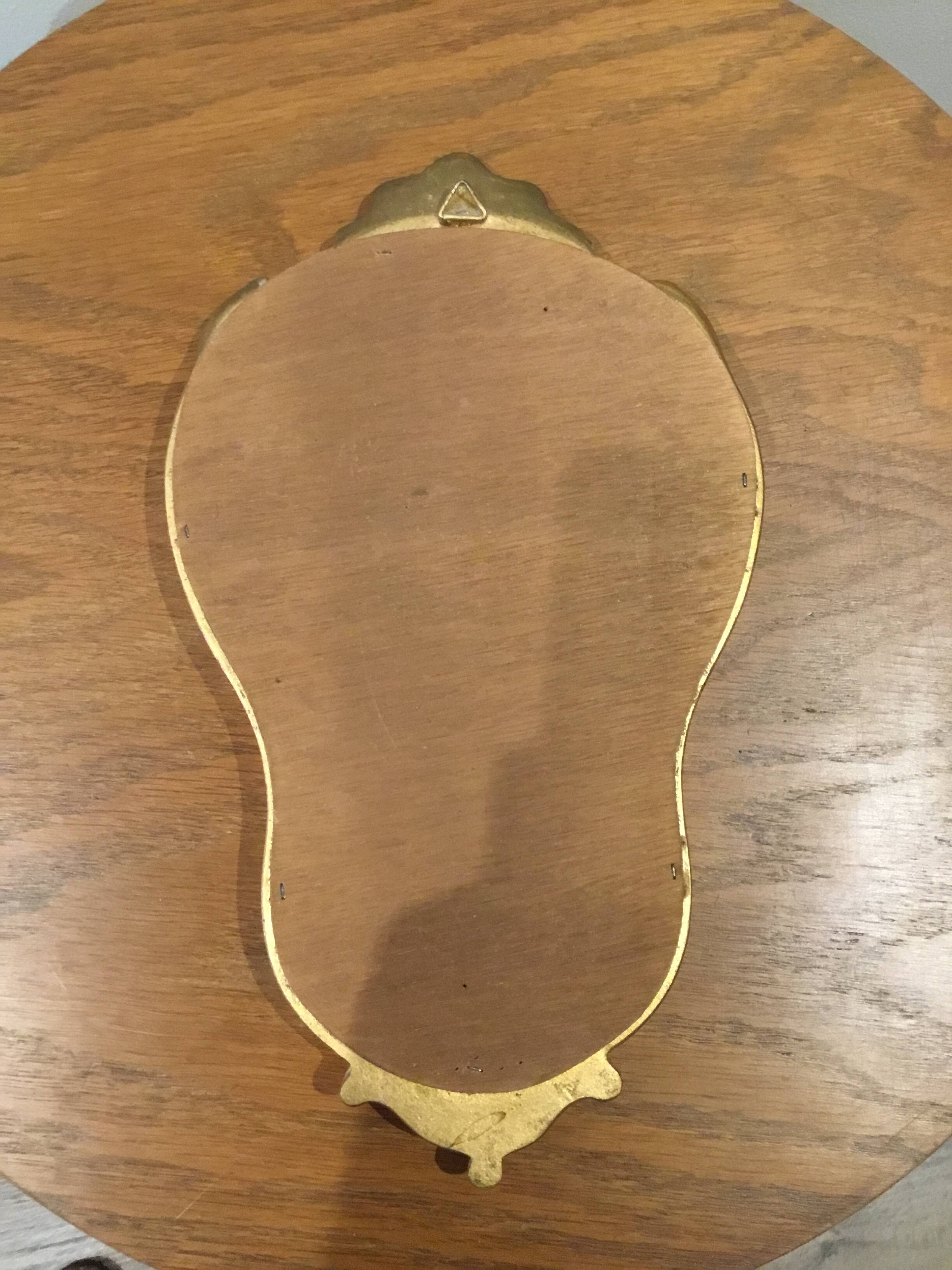Golden wooden mirror in baroque style