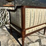 Low armchair in finely carved wood in the Louis XVI style from the 19th century
