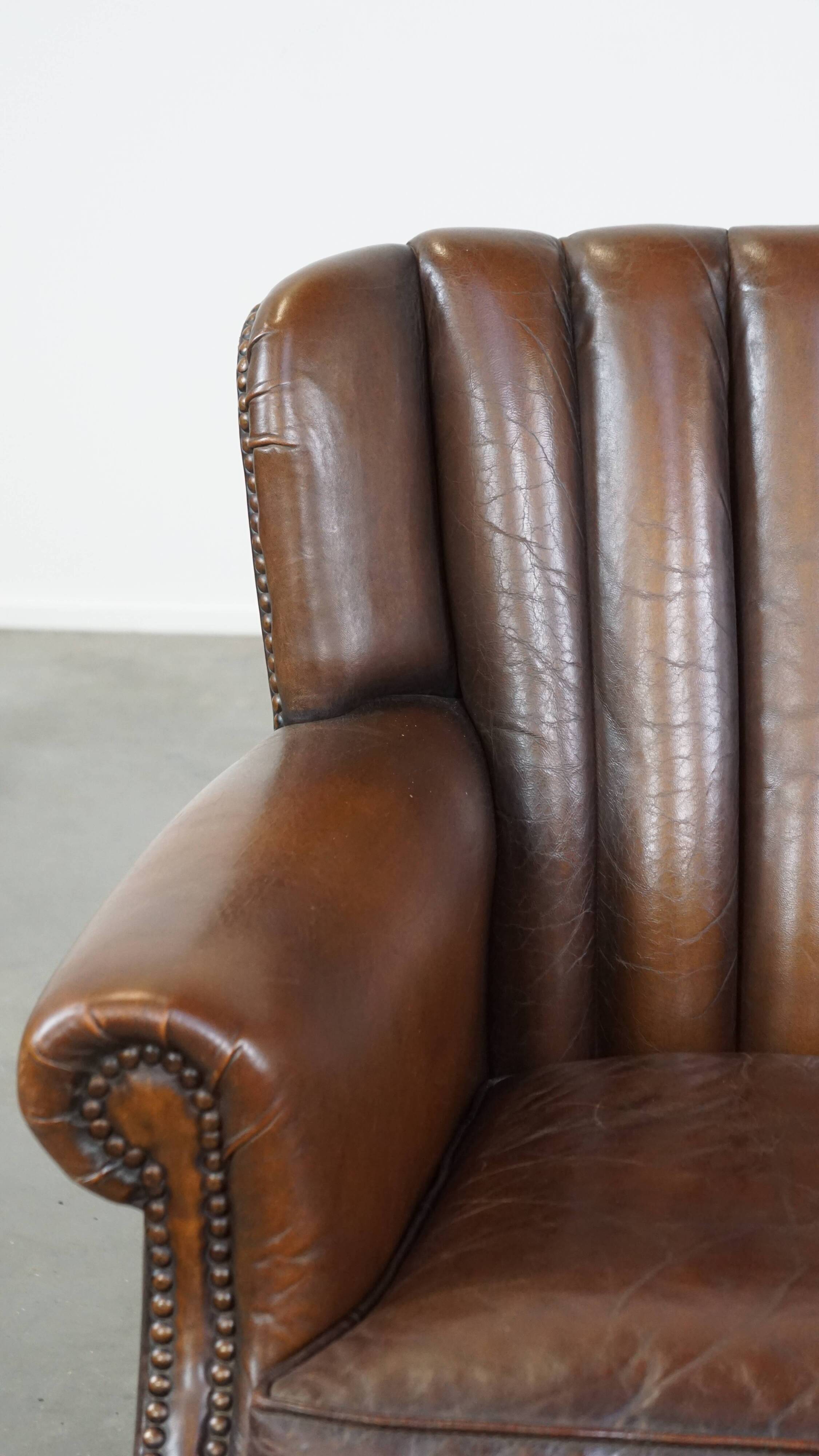 Sheep leather armchair finished with decorative nails