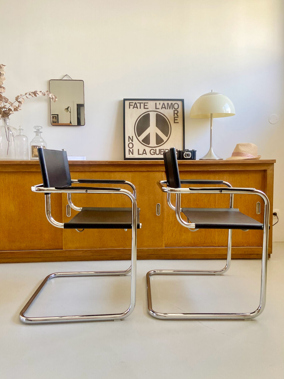 Pair of vintage chrome and black faux leather armchairs