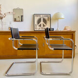 Pair of vintage chrome and black faux leather armchairs