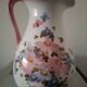Old ceramic pitcher with floral decoration.
