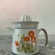Vintage stoneware jug and its citrus juicer.