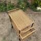 Vintage 1950s rolling dessert trolley in wicker and black tubing.
