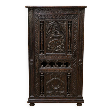 Richly carved oak cabinet, Gothic-inspired, dating from the 19th century.