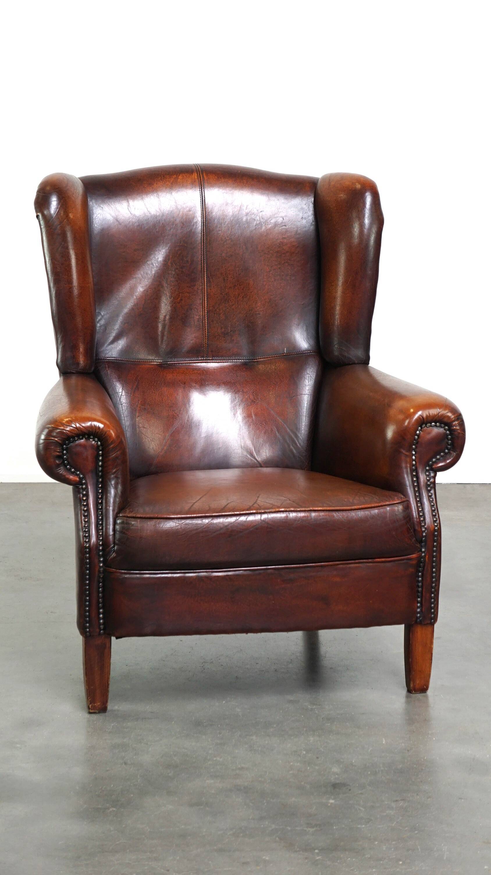 Luxurious sheepskin armchair with a fixed seat cushion and high seating comfort