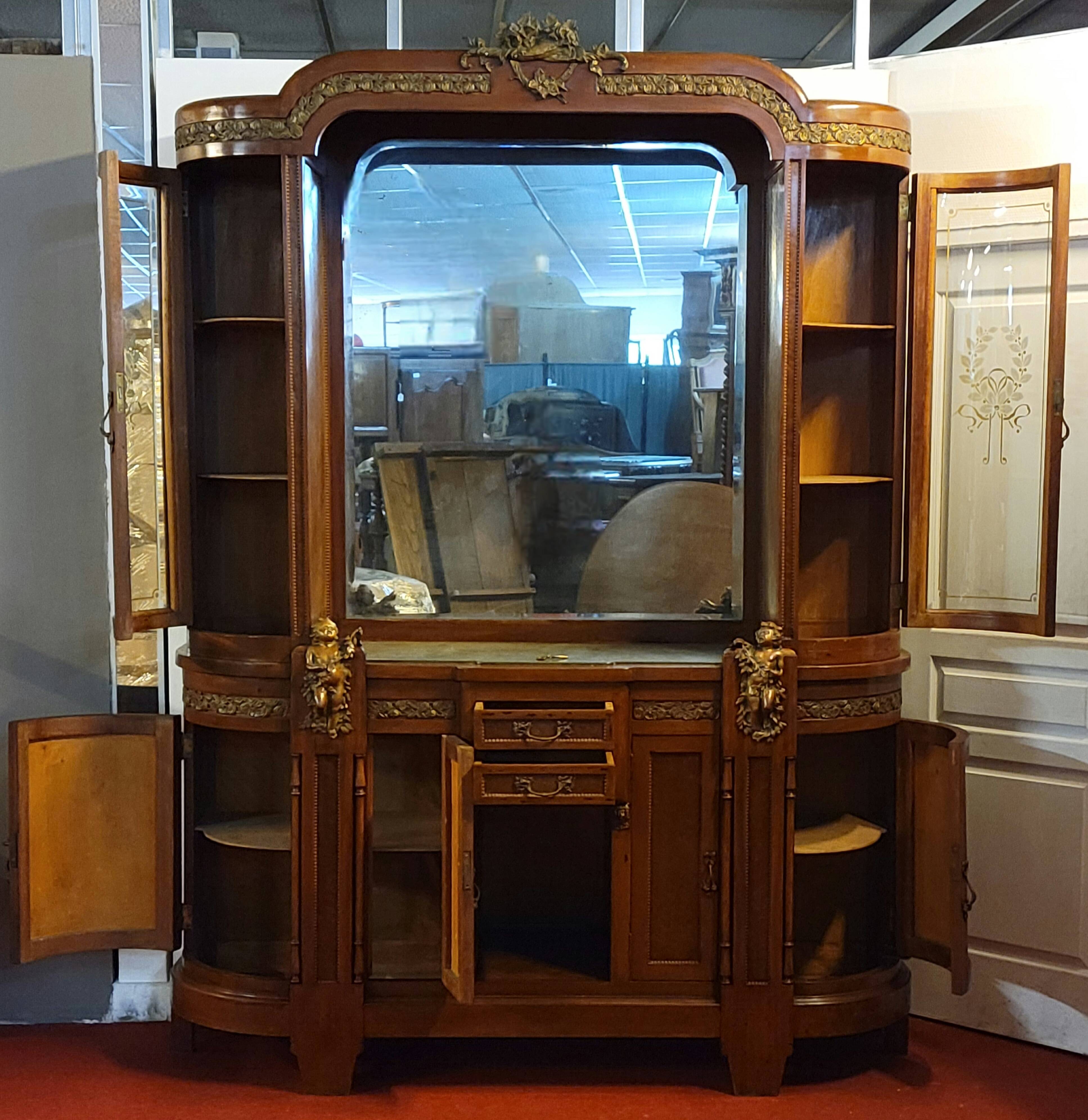 Empire style half-moon shaped mahogany bookcase with putti