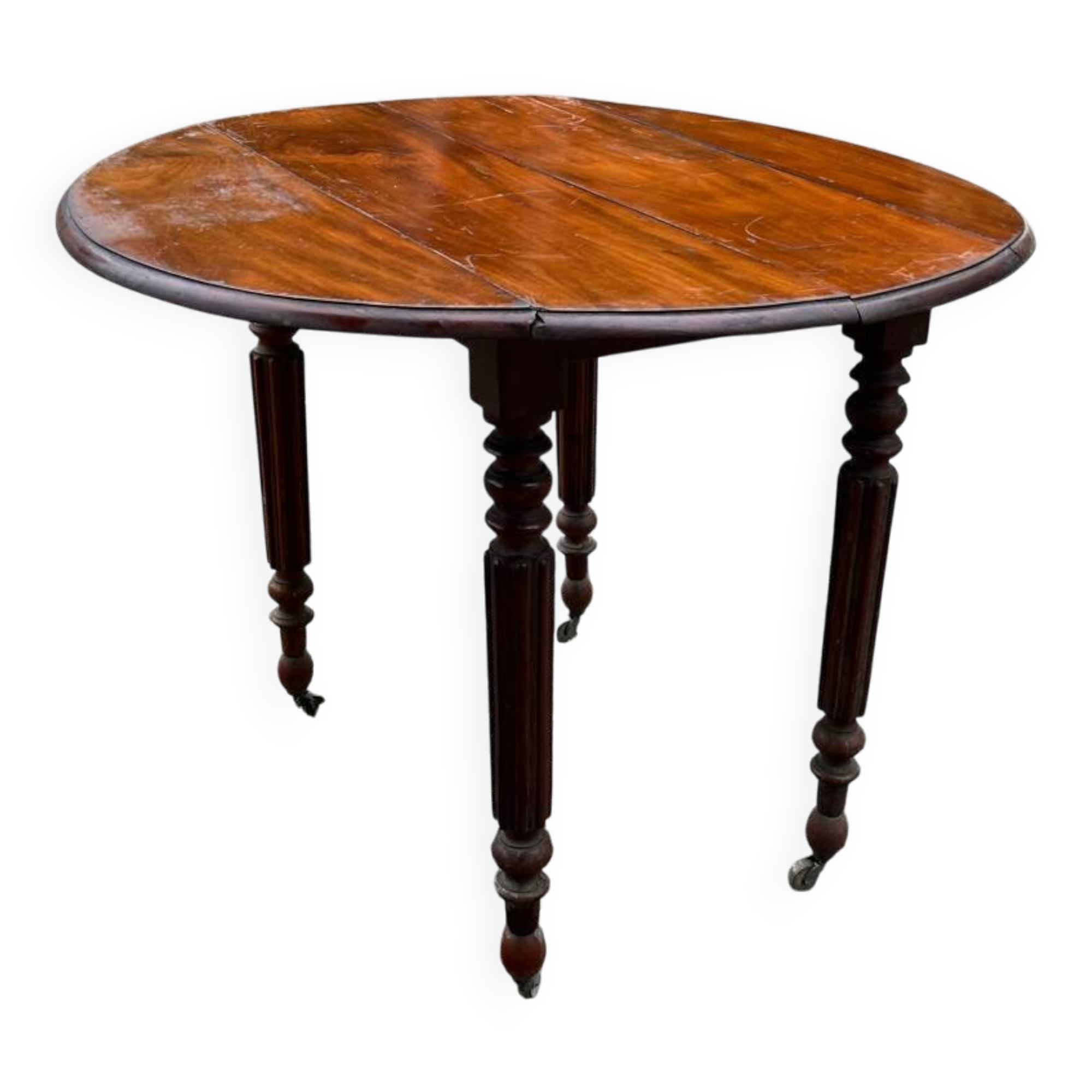 Antique round mahogany table, turned and fluted legs