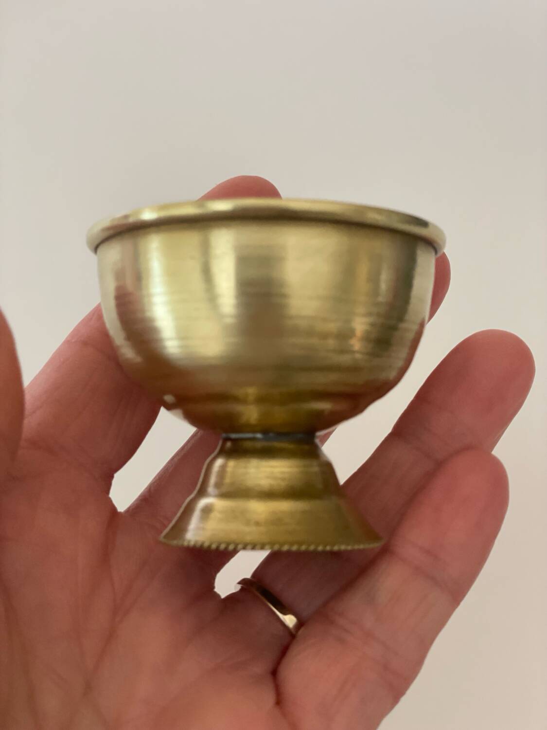 4 golden brass egg cups