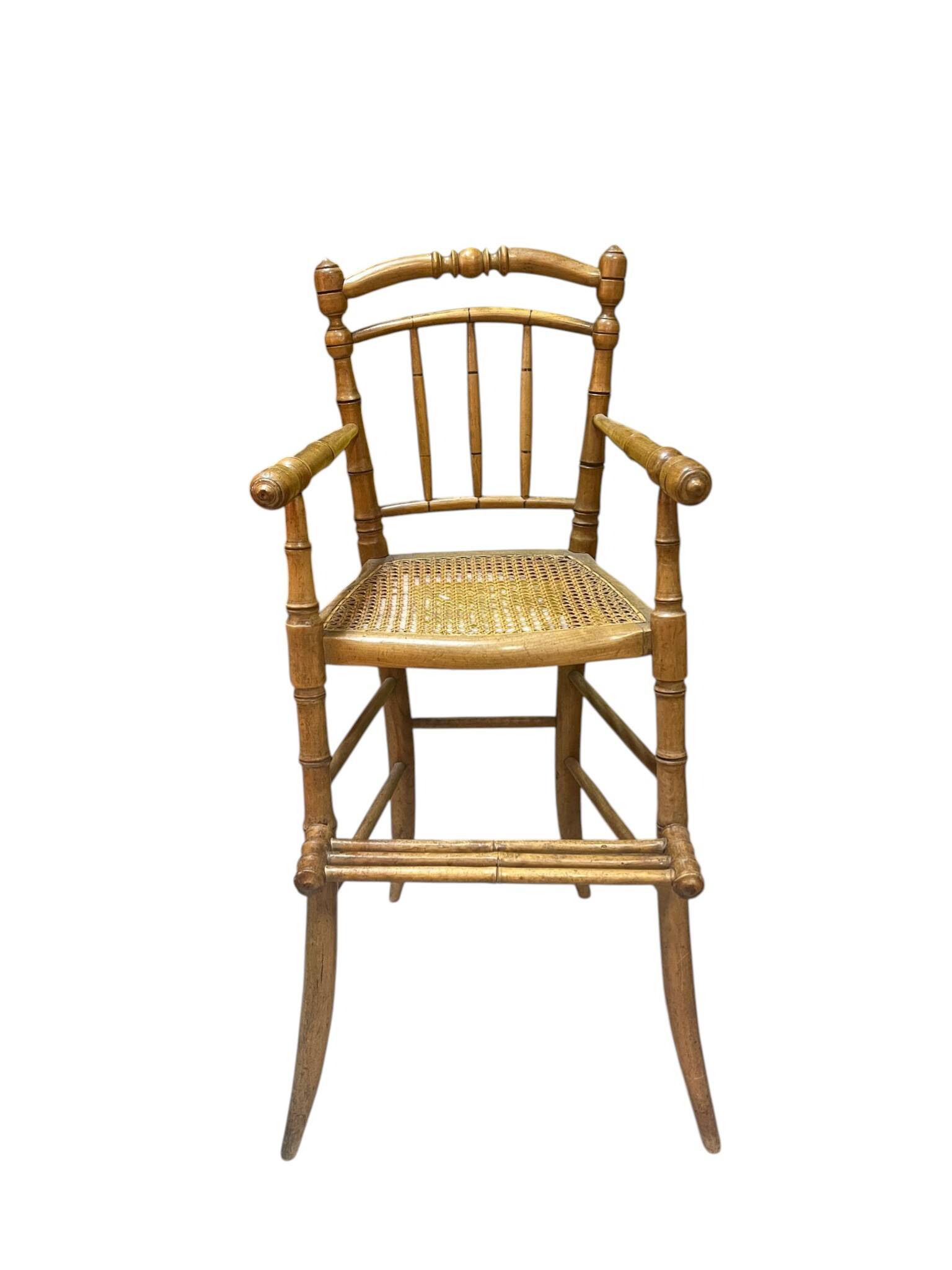 Antique bamboo caned baby chair from the early 20th century.