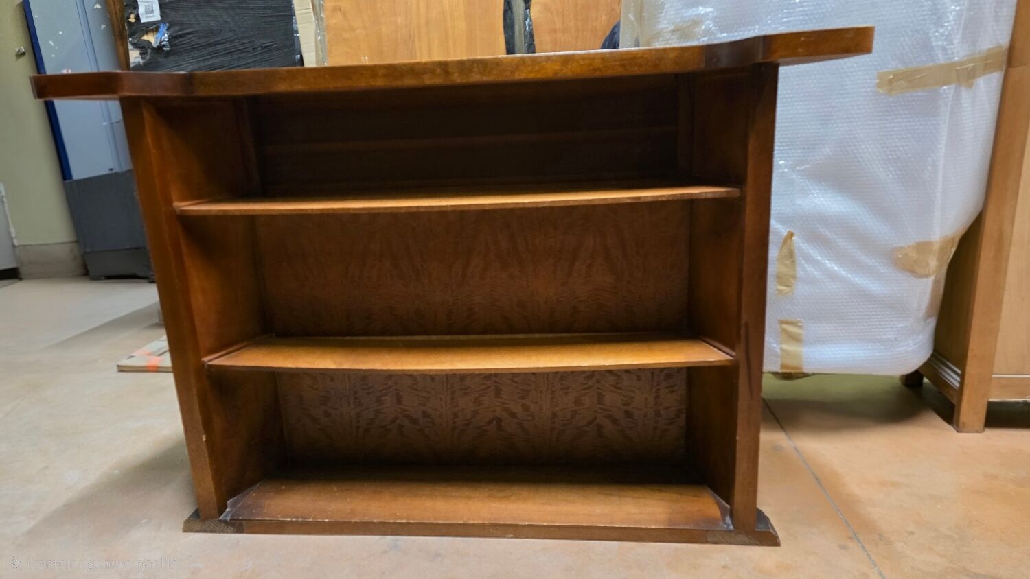 Solid wood bar cabinet with shelves and two stools.