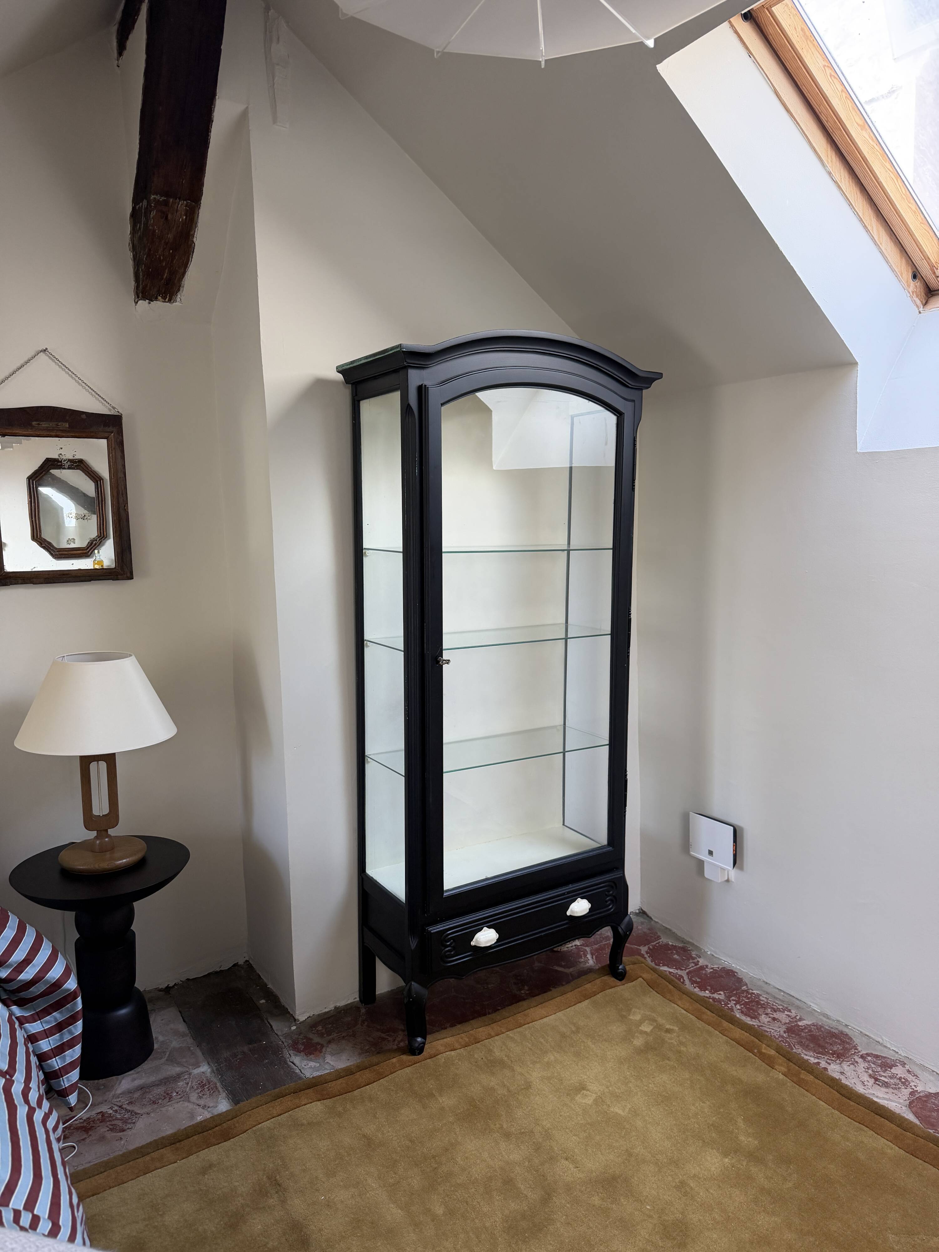 Antique display cabinet repainted in black.