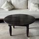 Antique round coffee table in Indonesian teak with turned legs.