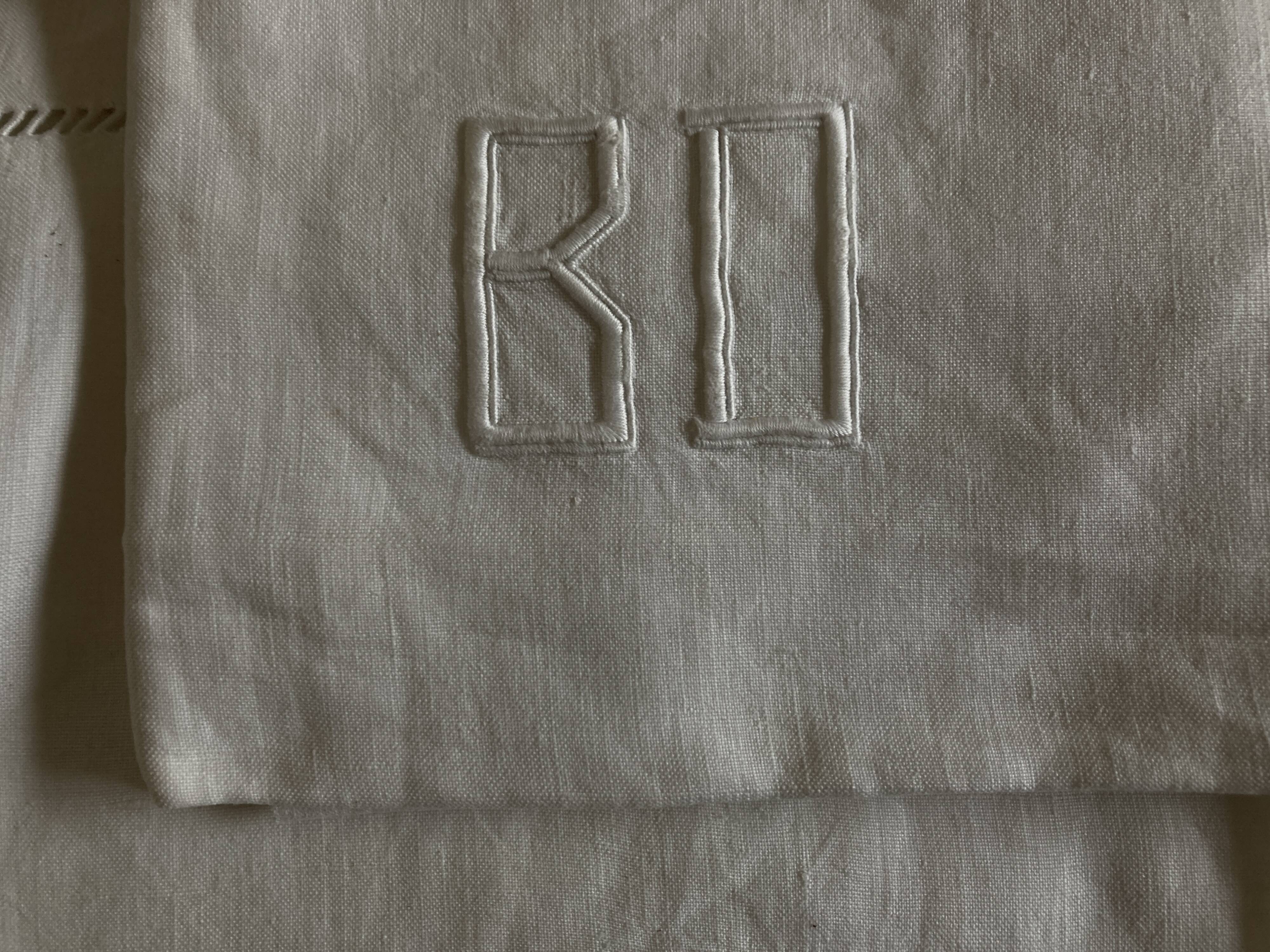 Pair of modernist linen pillowcases embroidered with comic strips