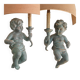 Pairs of wall lights, either two distinct cherubs.